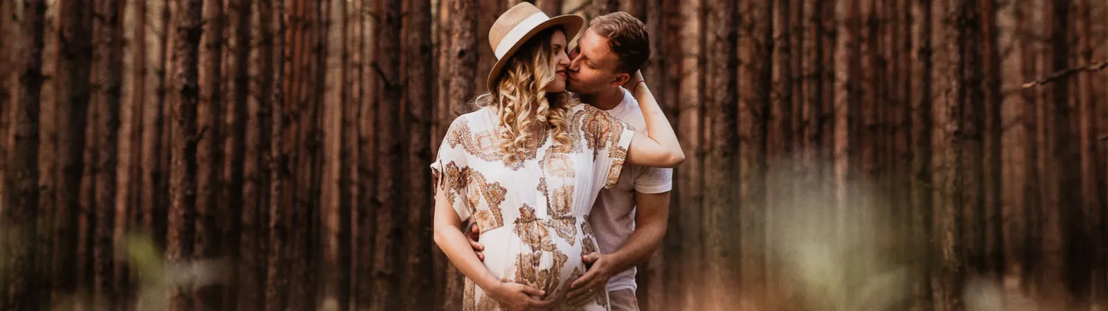 Pár v lese, tehotná žena s klobúkom